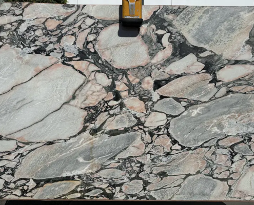 Viola Norte Dame – Dramatic white marble with deep plum and wine-colored veins; bold and luxurious centerpiece stone.