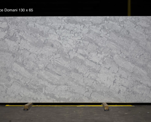 130 x 65 slab. Large-format gray and white quartz with natural movement for luxury kitchens and statement countertop projects.