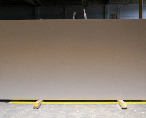 Deep taupe-gray quartz with a smooth solid appearance for bold modern kitchens and contemporary countertop designs.