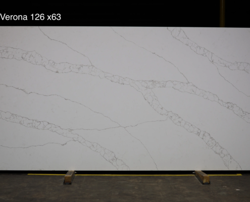 126 x 63 slab. White quartz with bold warm veining for high-end kitchens, large islands, and luxury statement spaces.